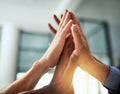 High five of a diverse group of businesspeople celebrate, unite and support each other. Closeup of a multiethnic