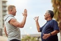 High five, hand shake and senior friends in the city outdoor for a workout, exercise or running. Teamwork, motivation Royalty Free Stock Photo