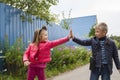 high five. Happy children greet each other outdooes. Image with selective focus Royalty Free Stock Photo