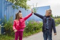high five. Happy children greet each other outdooes. Image with selective focus Royalty Free Stock Photo
