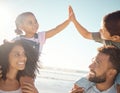 High five, kids and parents at the beach on vacation, holiday and enjoying the sunny day. Family, father and mother on a Royalty Free Stock Photo