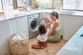 High five, laundry and washing machine with mother and daughter for helping, learning and cleaning. Housekeeping Royalty Free Stock Photo