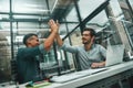 High-five Two young and handsome men in casual wear colleagues giving each other high-five and smiling while working in Royalty Free Stock Photo