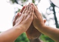 High fives of a diverse group of people. Closeup of multiethnic hands touching in the air. Group give high five as a Royalty Free Stock Photo