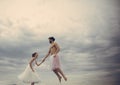 High flying romance. Couple in love fly in clouds. Young woman and man hold hands in sky. happiness and eternal love