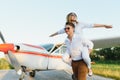 High flying romance. Front view of smiling young woman piggybacking on her boyfriend while keeping arms outstretched. Private