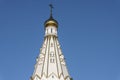 The high gabled roof of a Christian church with a gilded dome and a cross against a blue sky Royalty Free Stock Photo