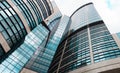 High glass office building with clouds. background