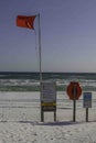 High Hazard Florida Gulf Beach Red Warning Flag, Life Throw, and Signs Royalty Free Stock Photo