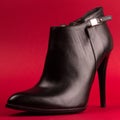 High heel black shoe on red background Royalty Free Stock Photo