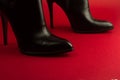 High heel black shoes on red background Royalty Free Stock Photo