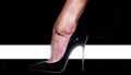 High heel. Fashion. Female foot in a black shoe. High Fashion Week. High rise of the foot. Elegant female legs Royalty Free Stock Photo