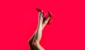 High heel shoes. Beautiful legs woman. Pretty female legs with red high heels on red background. Perfect female legs Royalty Free Stock Photo