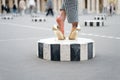 High heel shoes on female feet on city square. Legs in glamour golden shoes paris, france. Fashion shoes on column outdoor. Fashio Royalty Free Stock Photo