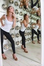 high heel woman poses against stage lights with surreal reflections