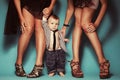 High heels family concept. Stylish baby boy standing with his fashionable mother and aunt. Girls in stylish peep toes shoes. Royalty Free Stock Photo