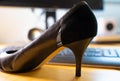 High heels on an office desk at workplace. Royalty Free Stock Photo