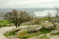 a tree and large boulders on top of a high hill Royalty Free Stock Photo