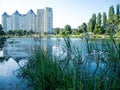 High houses above the lake. Urban landscape with nature.