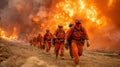 Courageous firefighters in orange suits moving through massive fire explosion, emergency response action scene Royalty Free Stock Photo