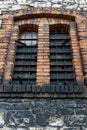 High industrial double window, barred, in brick wall Royalty Free Stock Photo