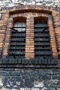 High industrial double window, barred, in brick wall