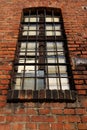 High industrial window, barred, in brick wall