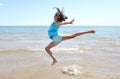 High jump of a very happy athlete during training on the seashor