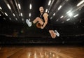 High jump. Young professional basketball player playing basketball at basketball court with people fans. Photoreal 3d