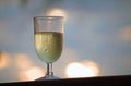 HIGH KEY IMAGE OF A GLASS WITH WHITE WINE AT SUNSET Royalty Free Stock Photo