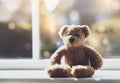High key light sad teddy bear sitting near window in sunny day, Lonely brown bear sitting alone at home, Concept to social Royalty Free Stock Photo