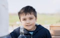 High key portrait Kid looking at camera with smiling face, Happy young boy sitting outdoor cafe witing for food, Positive Child Royalty Free Stock Photo