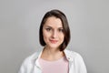 High key portrait of smiling young brunette multiethnic woman in pink tank and white shirt looking at camera Royalty Free Stock Photo