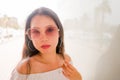 High key portrait of young beautiful and attractive Asian Korean woman wearing cool sunglasses posing outdoors on a sunny day in Royalty Free Stock Photo