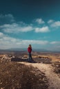 In a sun-kissed landscape, a person poses