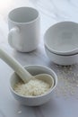 High key white rice in bowl with cup and spoon. Royalty Free Stock Photo