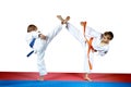 High kicks legs two athletes are training on the red and blue mat