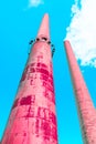 High living coral pink industrial smokestack factories produce smoke, concept of a surreal futuristic future and pollution