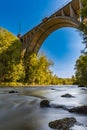 High long railway bridge over small river full of big stones