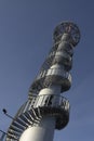 High lookout tower with spiral metal stairs against a beautiful blue sky Royalty Free Stock Photo