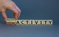 High or low activity symbol. Businessman hand turns cubes and changes words `low activity` to `hugh activity`. Business and hi Royalty Free Stock Photo