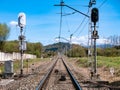 High luminous railway signals located in the middle of the track and their corresponding ASFA beacons located between the rails