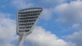 High mast on a background of a cloudy sky. Light pole under the blue sky. Space for text. Light pole tower with blue sky Royalty Free Stock Photo