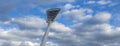 High mast on a background of a cloudy sky. Light pole under the blue sky. Space for text. Light pole tower with blue sky Royalty Free Stock Photo