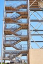 High metal construction against blue sky. Tower stairs on water slide in the water park Royalty Free Stock Photo