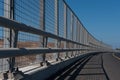 High metal guardrail along an empty highway