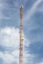 High metal mobile communications tower cell site with antennas against the sky. Vertical orientation. Royalty Free Stock Photo