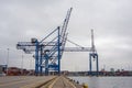 High modern blue cranes for loading of containers for ships Royalty Free Stock Photo