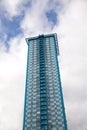 High modern residential building over blue sky with clouds Royalty Free Stock Photo