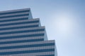 A high modern tower standing against sky in midday